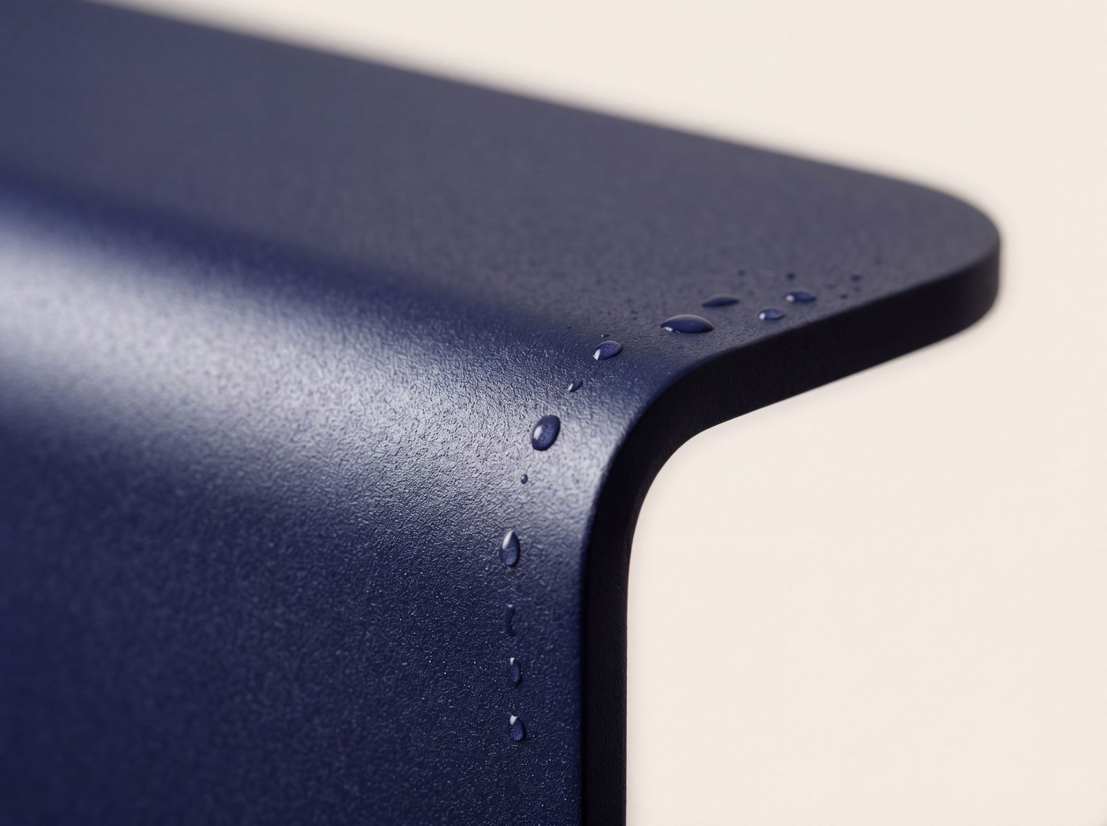 Powder-coated marine-grade steel finish — water beading on the matte, textured edge