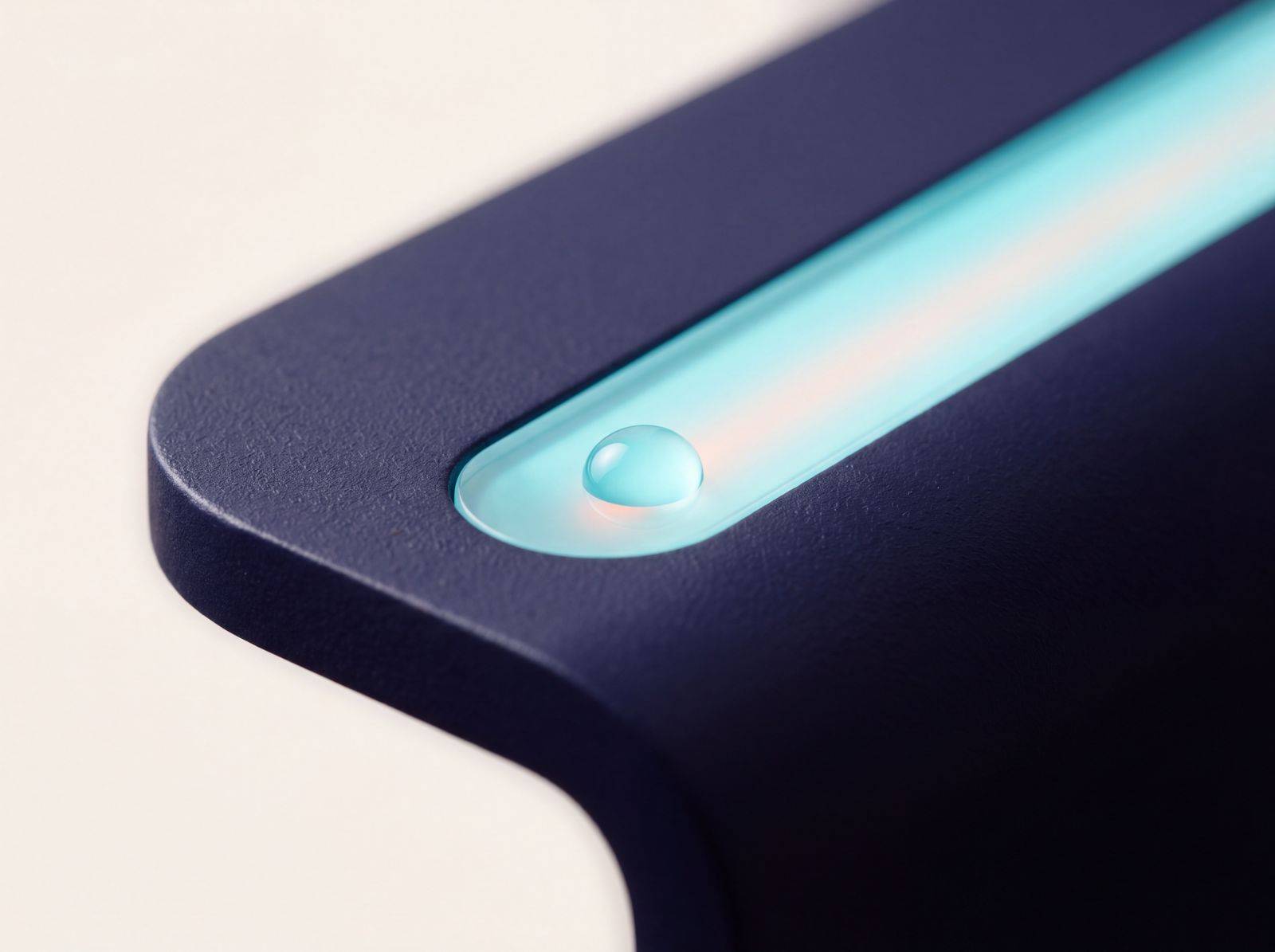 A sealed, gasketed light module glowing cyan, a water droplet resting on its surface